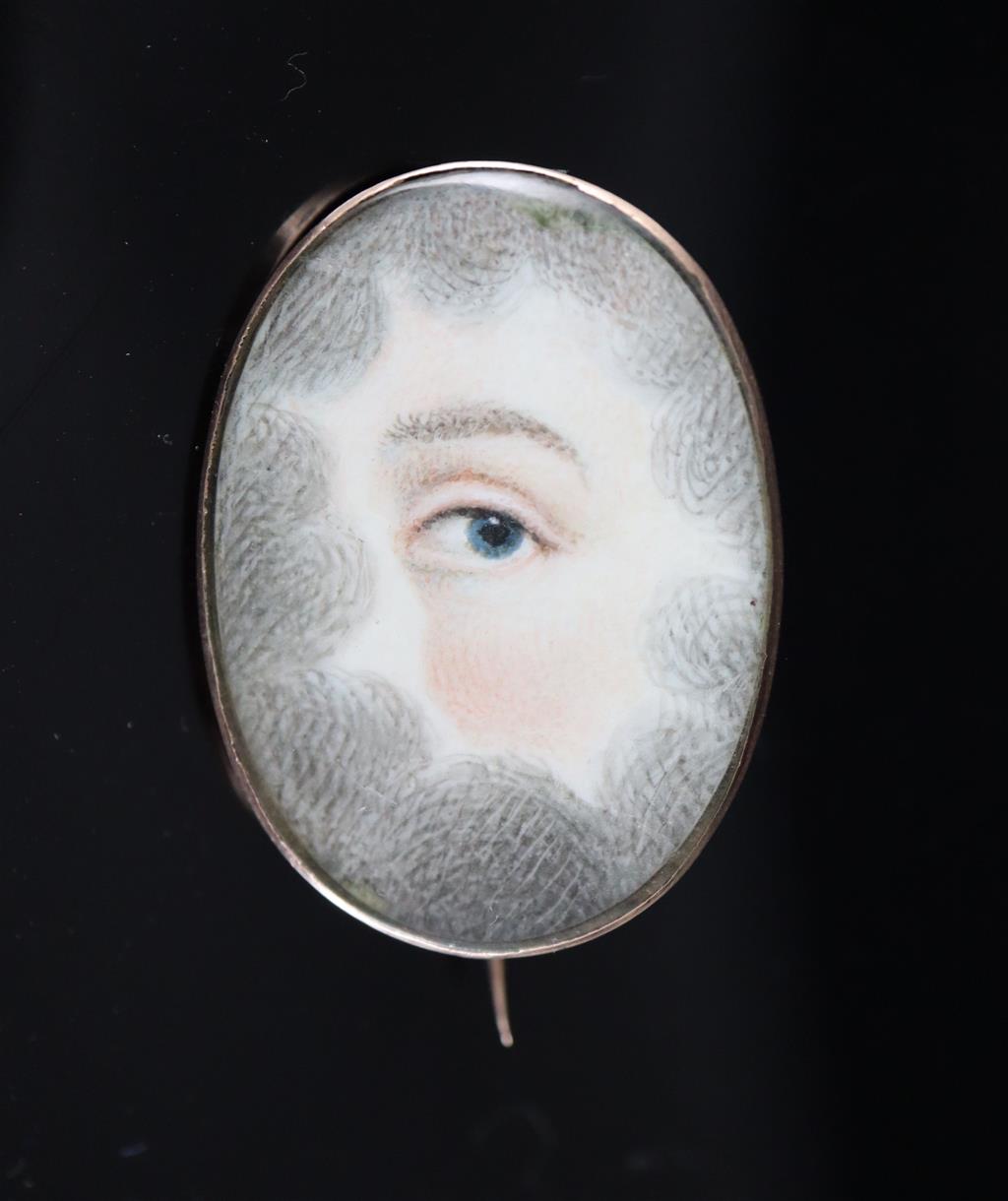 A Georgian gold mounted oval mourning brooch, with painted panel depicting an eye,
